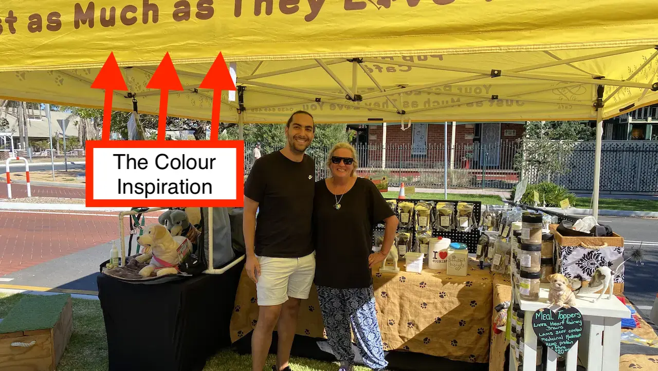 Pointing out the colours of the Pup Hub Cafe tent from a picture with Dom Tripodi and Jo Rugless at the markets.