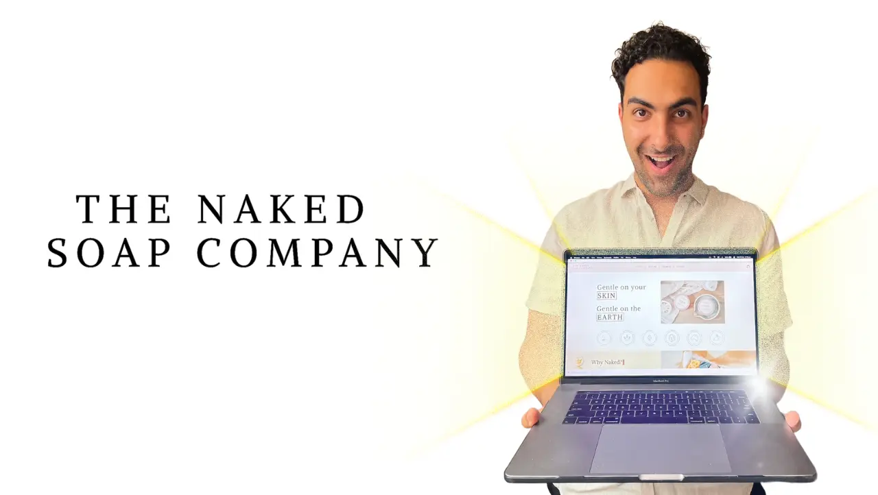 Dom Tripodi holding laptop displaying new website for The Naked Soap Company.